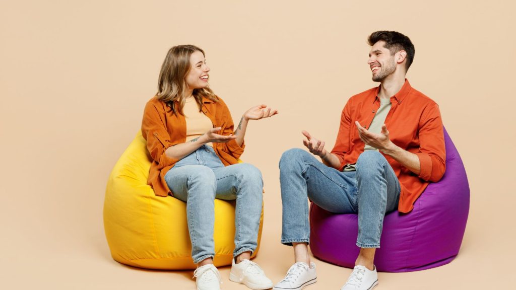 Two people enjoying conversation while sitting on a bean bag