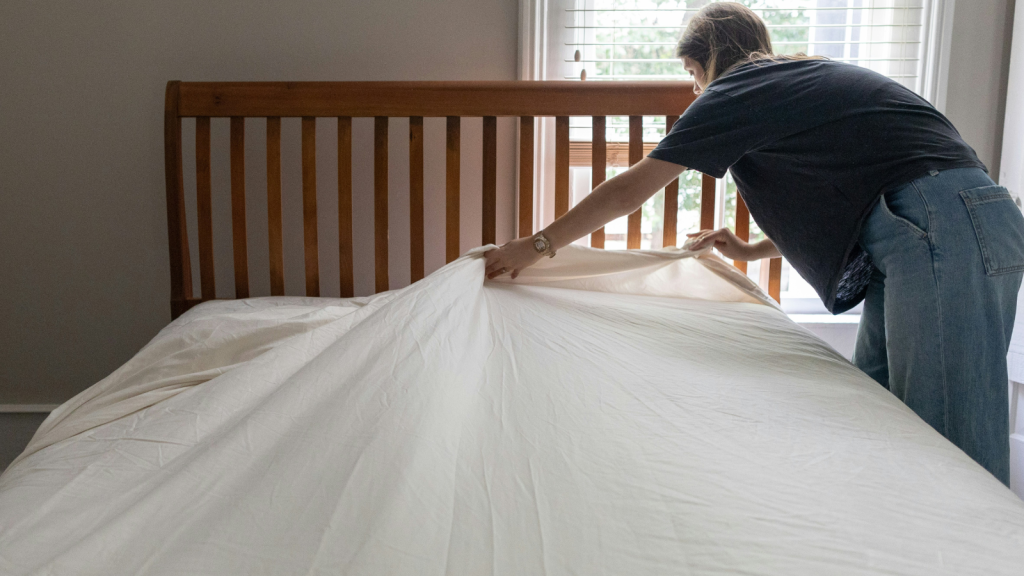 woman fixing the bed