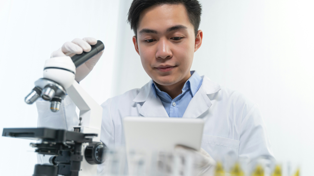 a scientist working on the microscope
