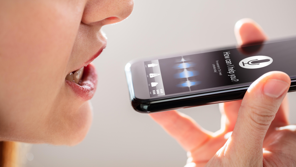 Woman Using Voice Recognition Function On Mobile Phone