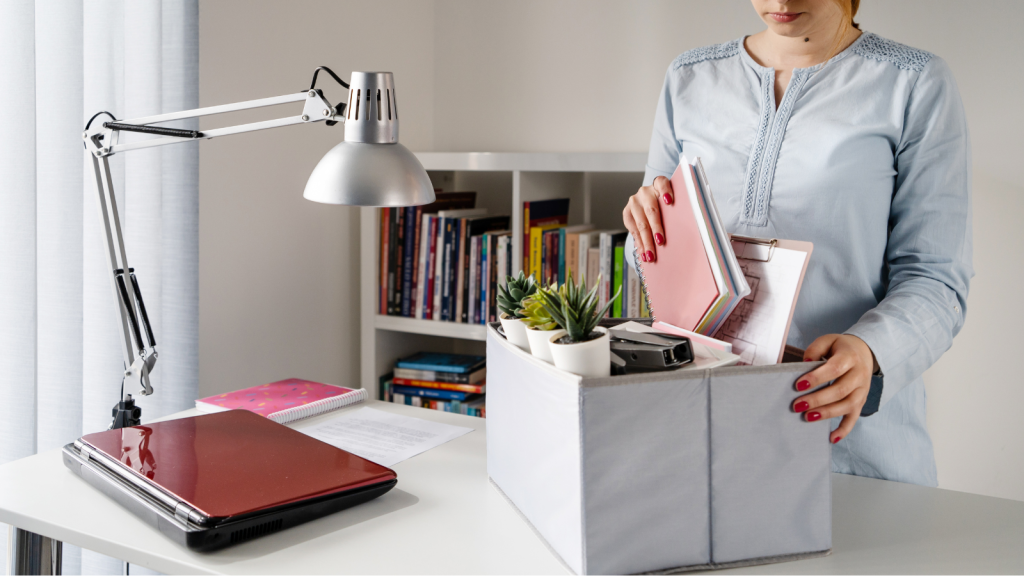 Woman decluttering, organising, cleaning desk