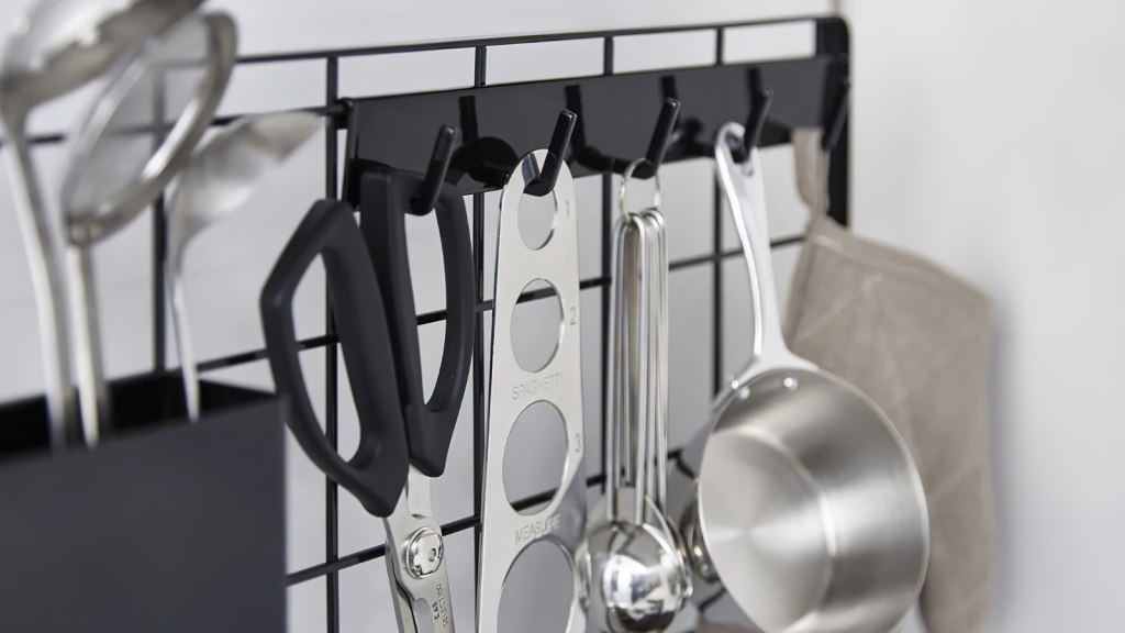 Cutlery hanging on the rack in kitchen interior