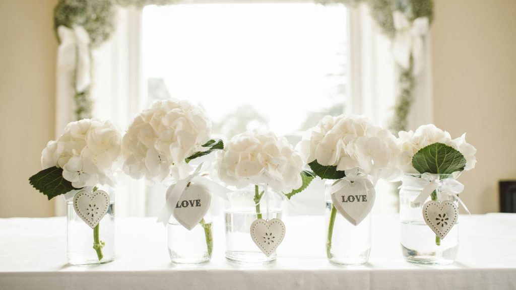 White flowers in glass jars centerpiece