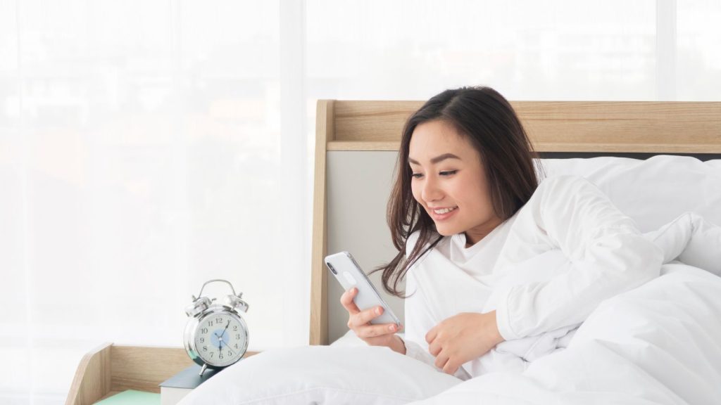 Woman checking her smartphone before getting ready for work