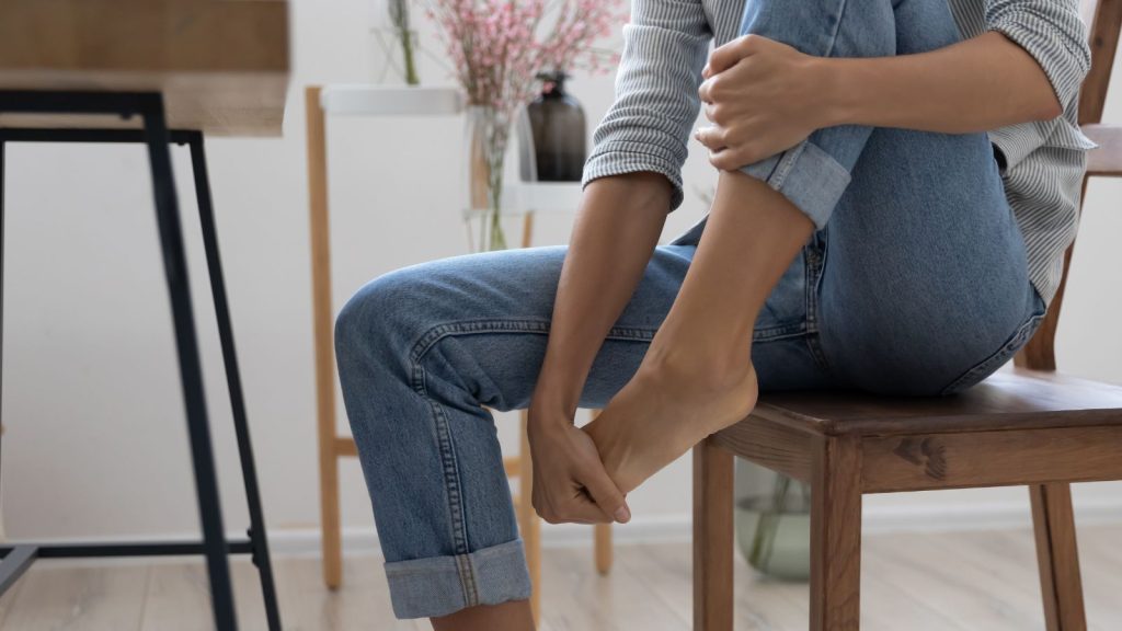 Woman doing ankle exercise while sitting