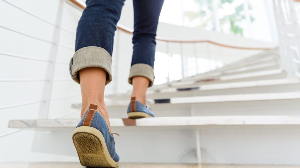 Woman lifting a foot onto the stairs