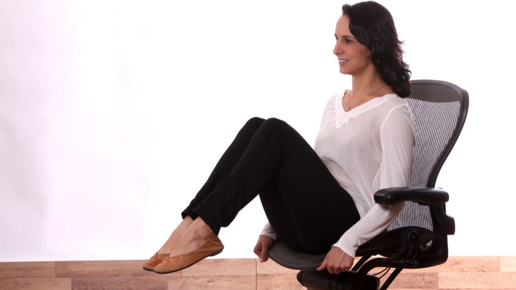 Woman stretching up on her chairs office