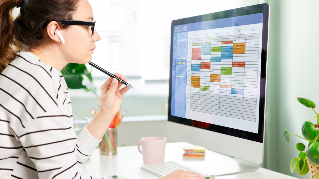 Woman using calendar on computer to improve time management