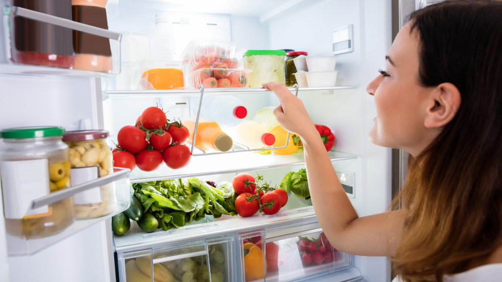 Young Woman Searching For Food In The Fridge