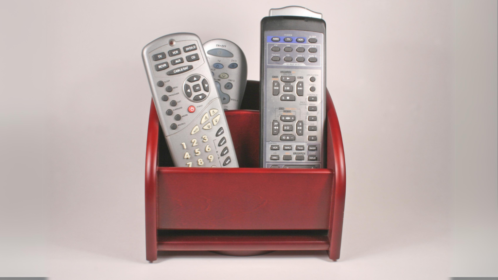 a brown wooden remote control caddy