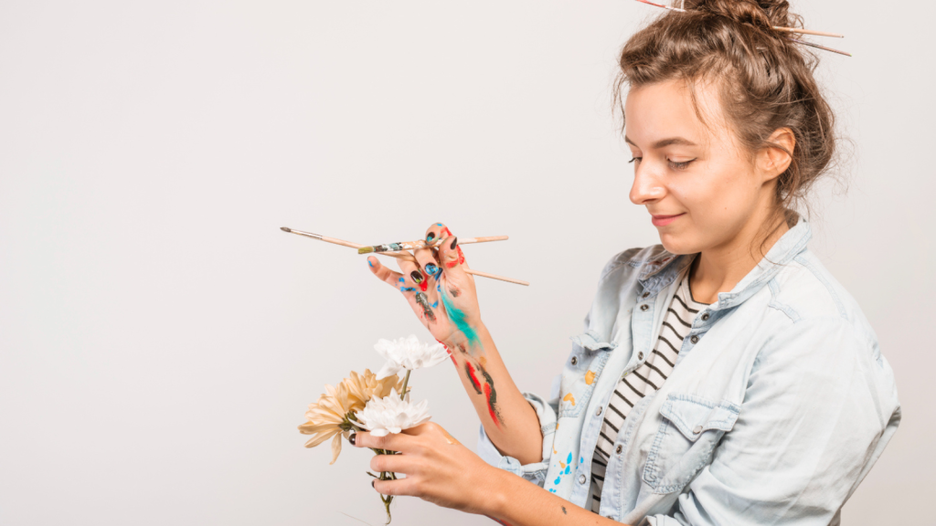 Portrait of female artist with paintbrushes