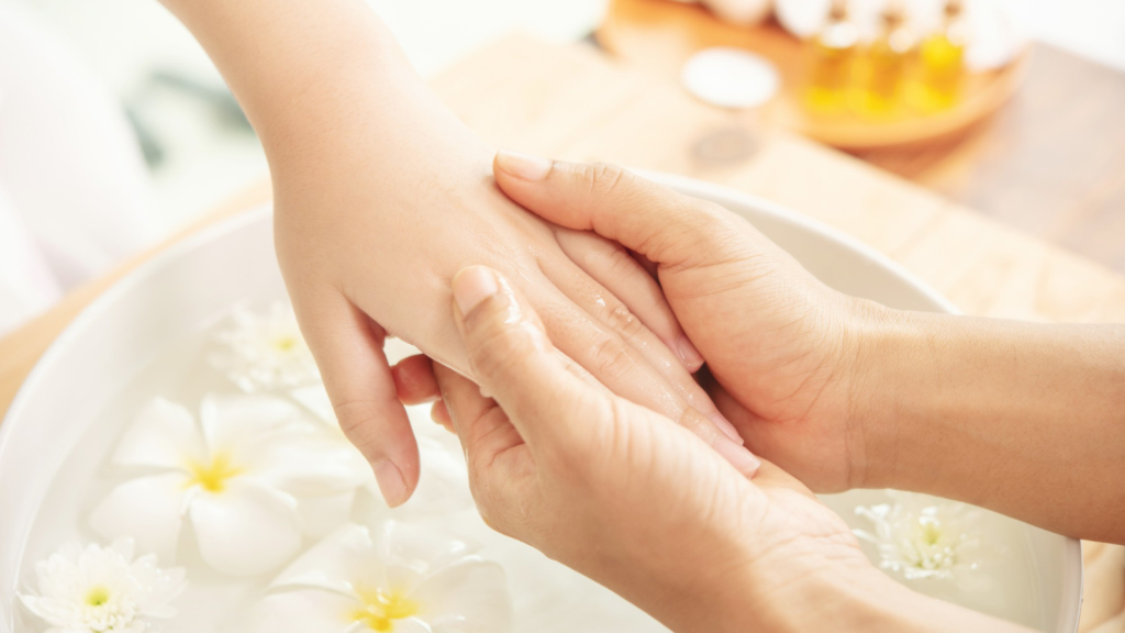 beautician massaging hand of female