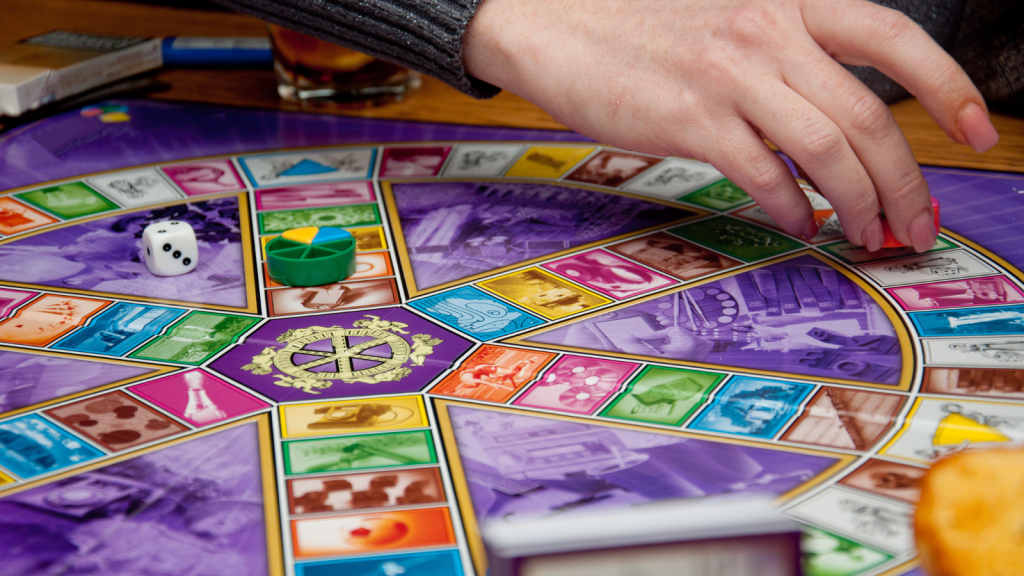 A girl playing trivia pursuit board game