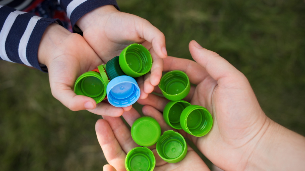 Kid puts plastic lids in mother's hands