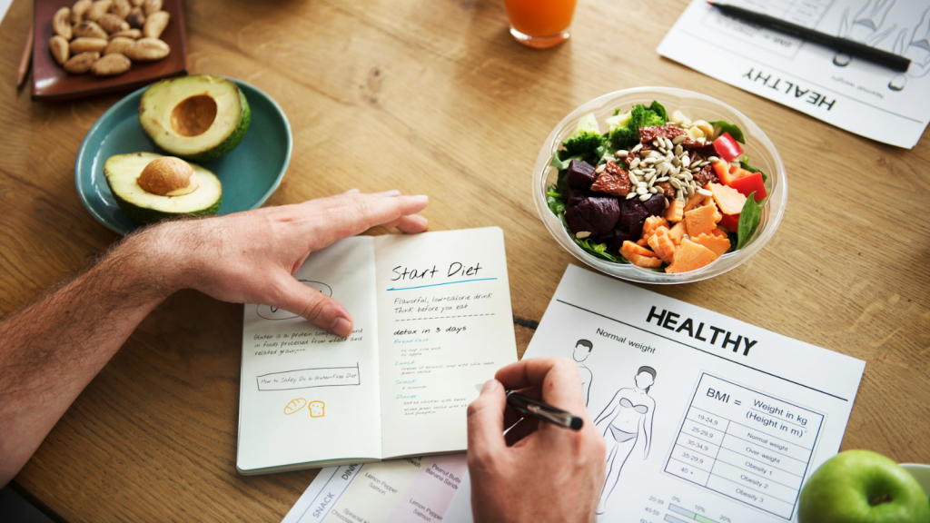 Person writing meal plan for healthy diet