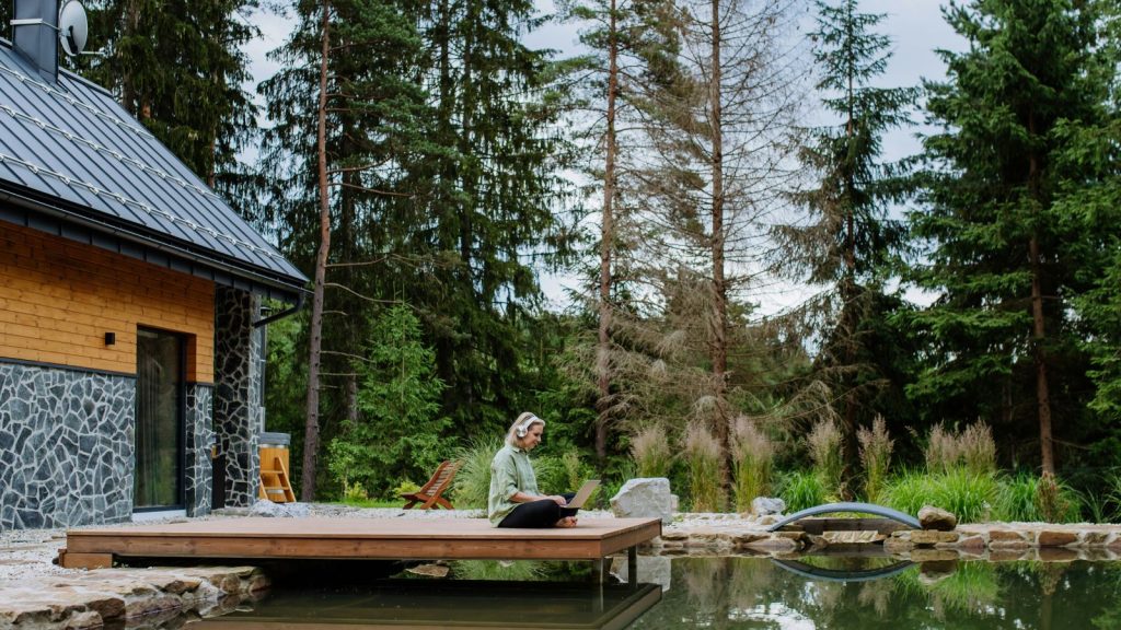 woman using laptop outside in nature