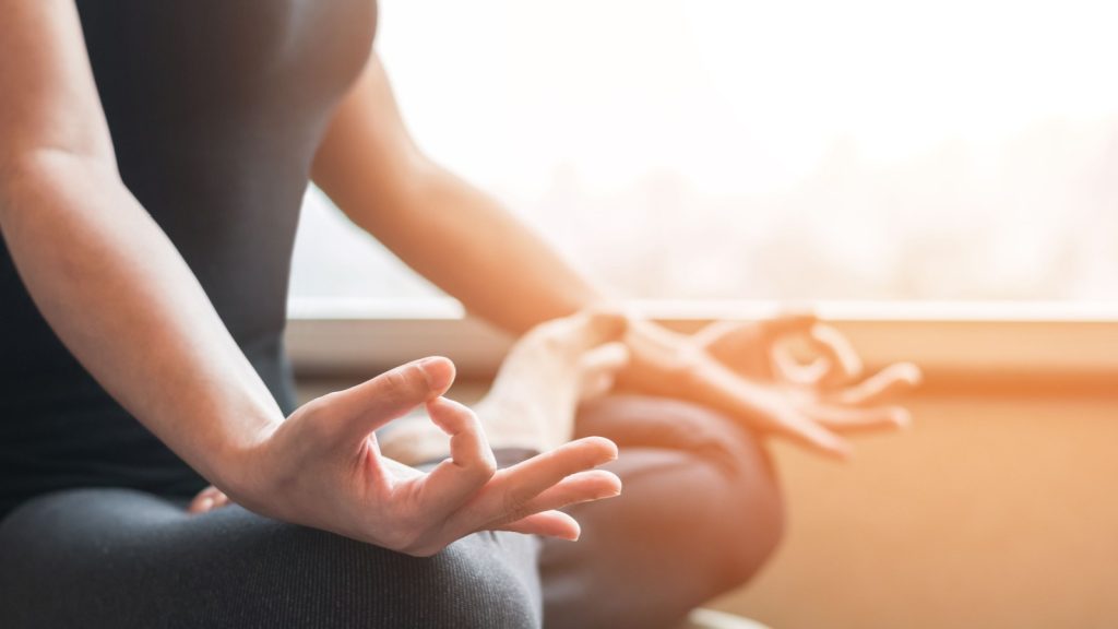 woman person in yoga lotus pose meditating