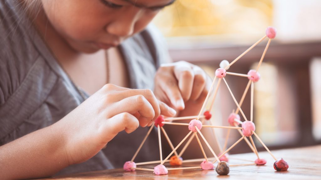 a girl crafting a toy