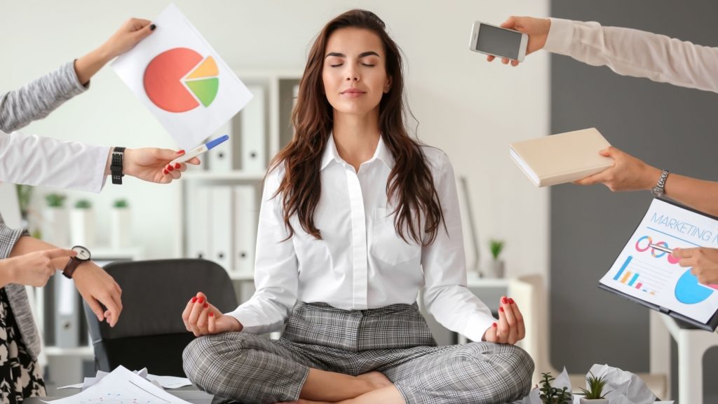 businesswoman with a lot of work to do meditating in office