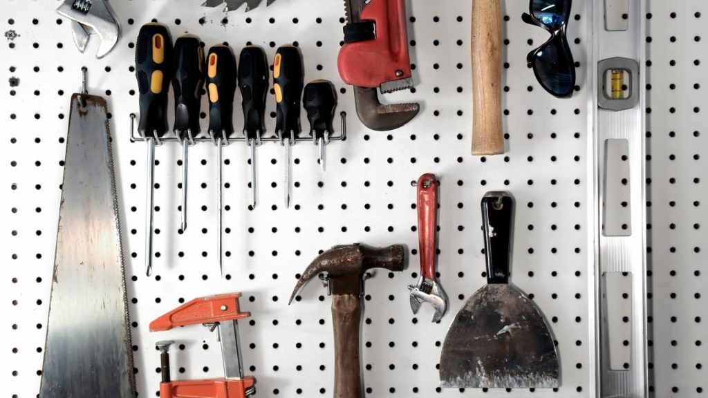 various carpentry tools in a garage on pegboard