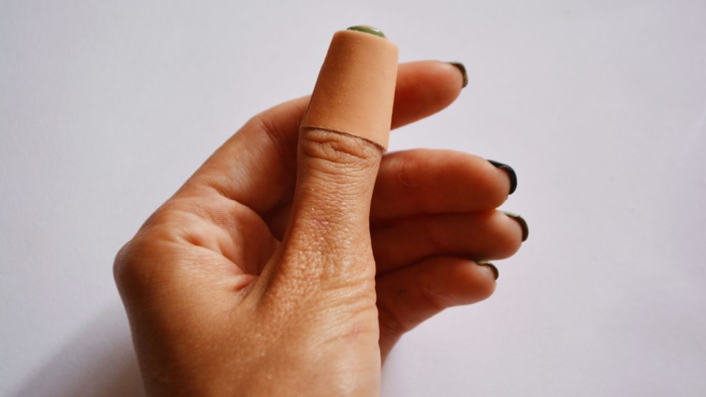 woman's hands with a band aid or plaster