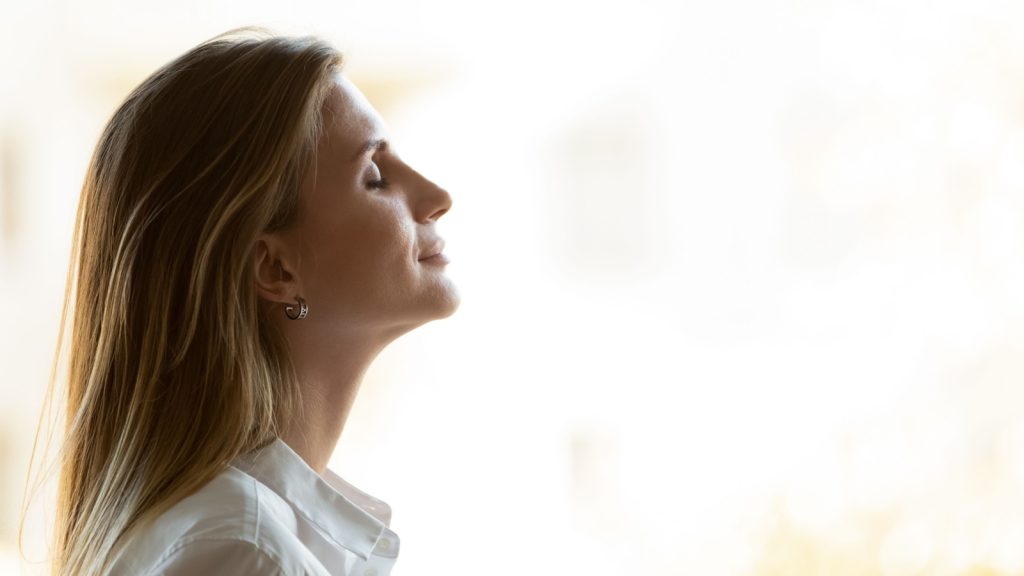 a woman practicing deep breathing