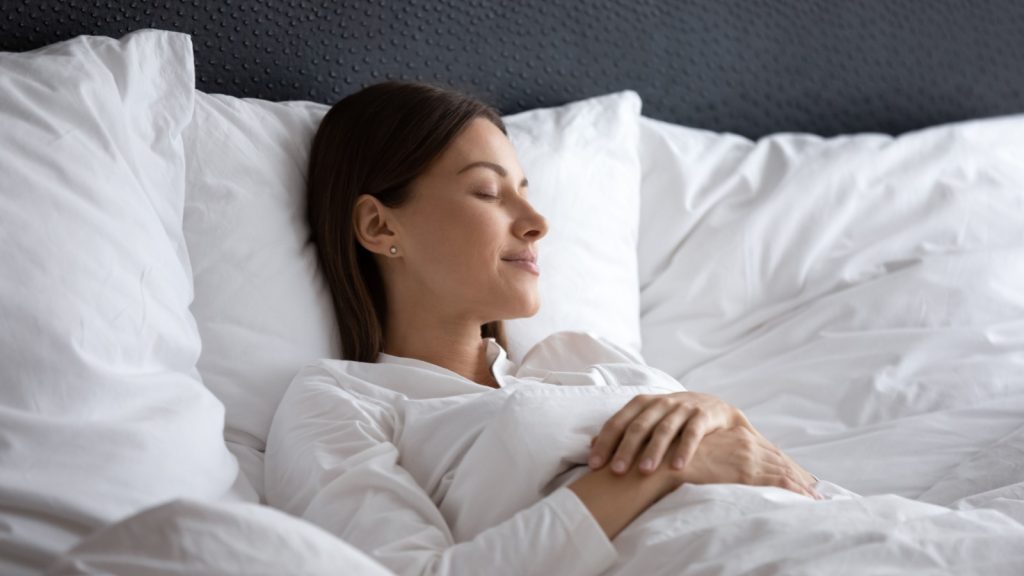 beautiful woman sleeping under warm blanket