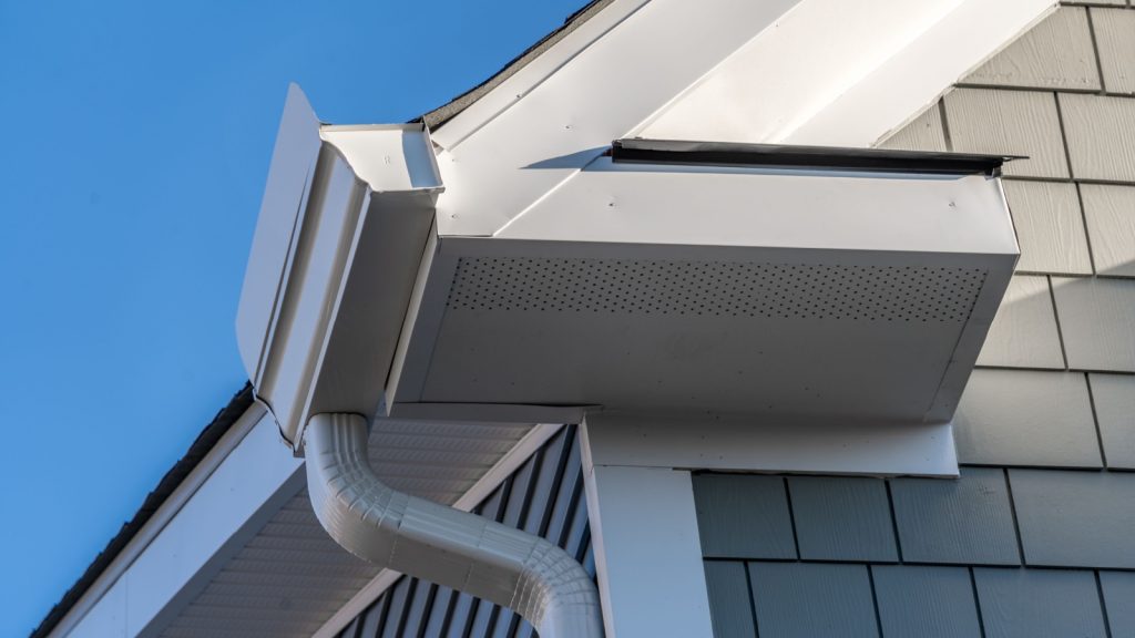 a splash guard installed in the corner of the roof gutter