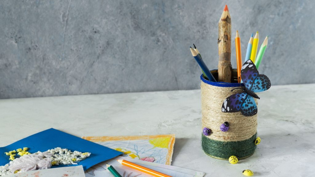 Decorated tin can with jute ropes and decorated with decorative elements.