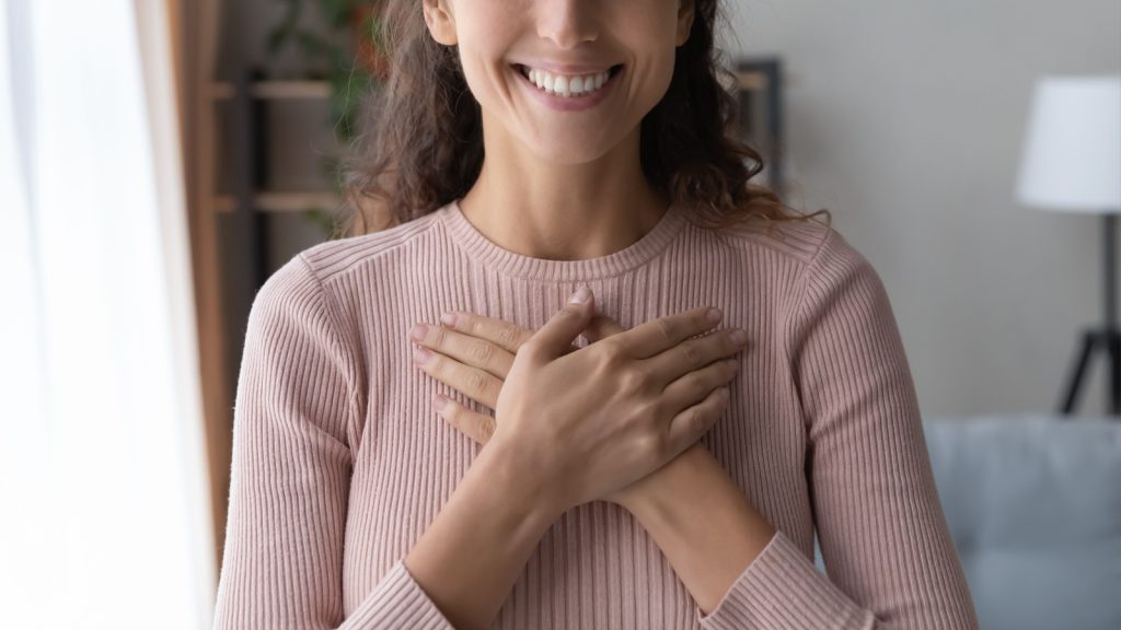 close-up image of woman smiling and happy