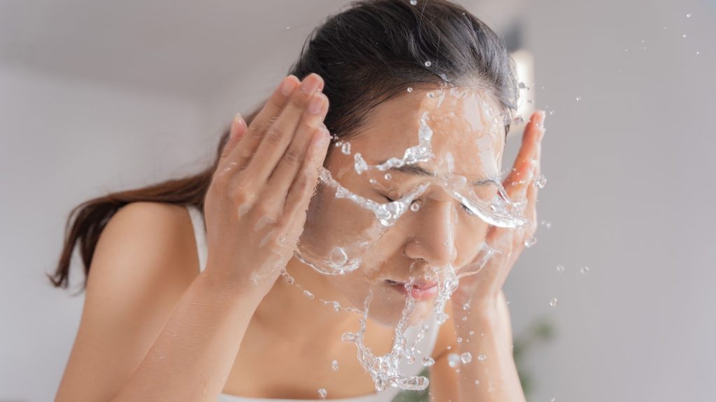 beautiful female asian use water to wash face