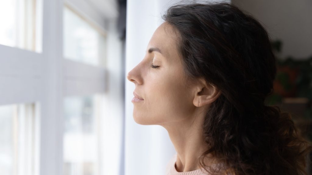 woman with eyes closed meditating