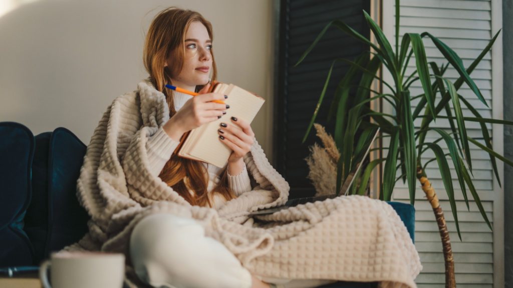 woman writing on her journal