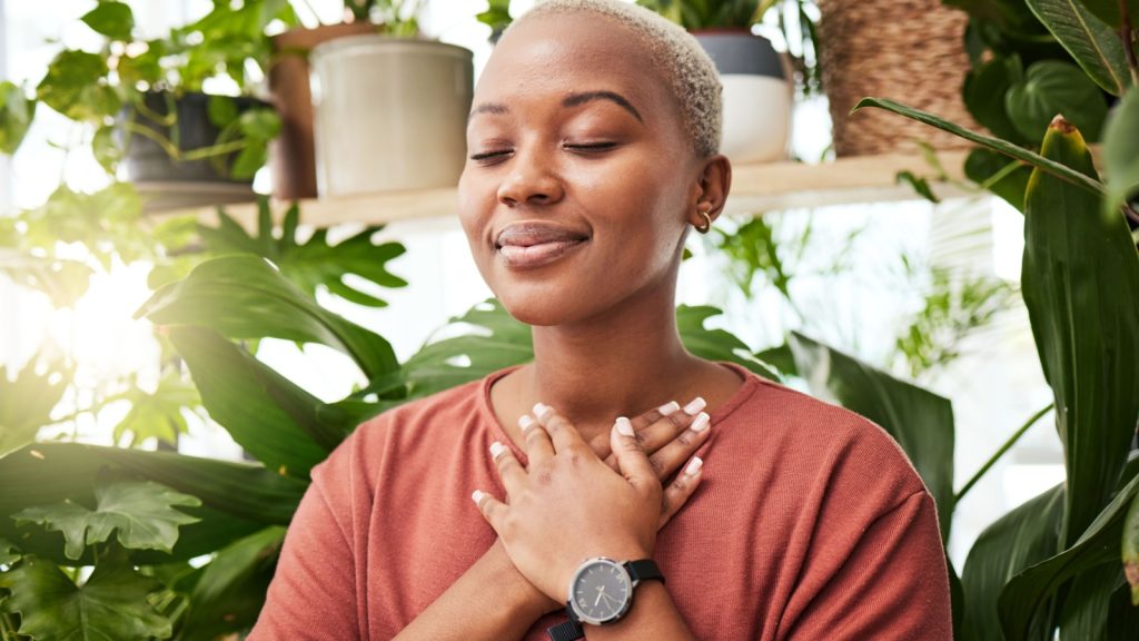 breathe, gratitude, and a young African female person with a relaxing peace mindset by an indoor greenhouse garden