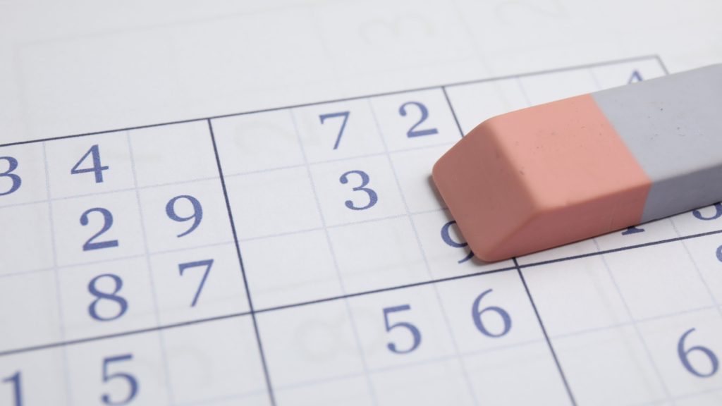 eraser on top of a calendar on a journal