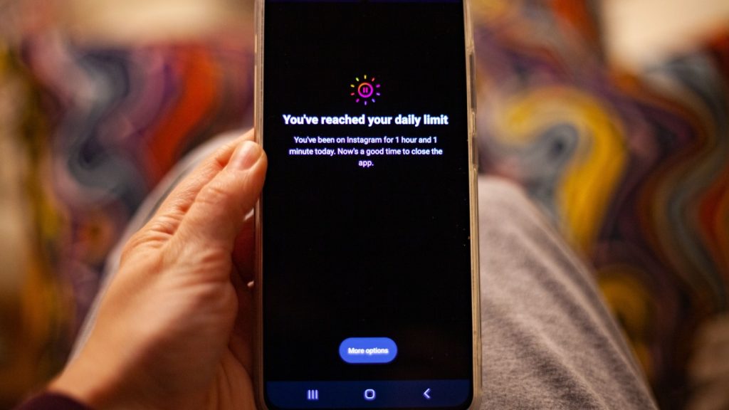 person holding phone with  Instagram time limit