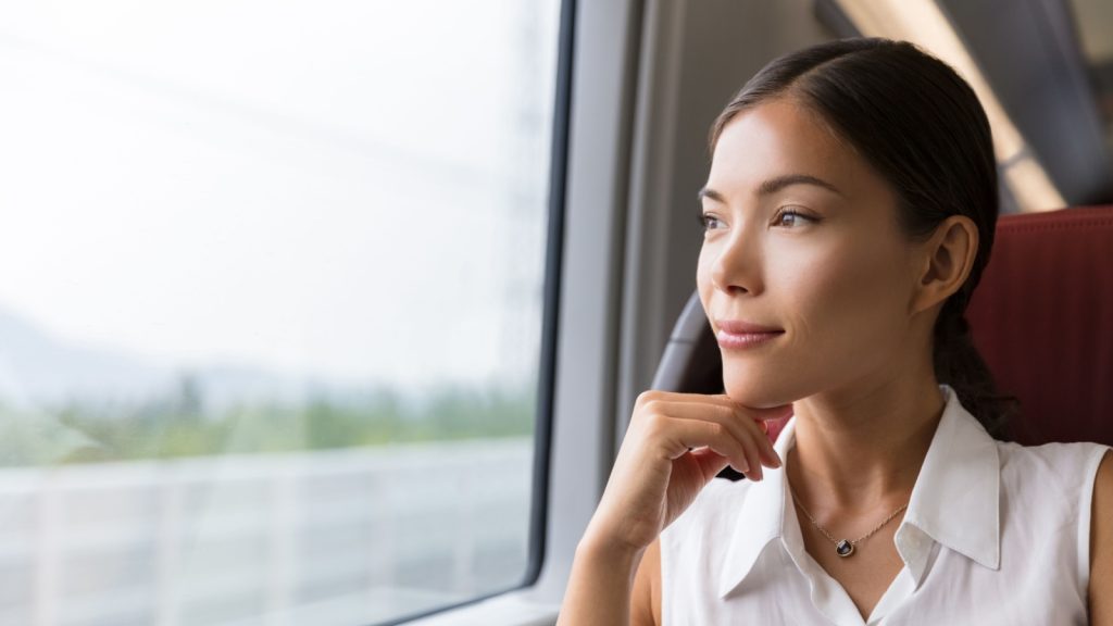 woman contemplating outdoor view from window