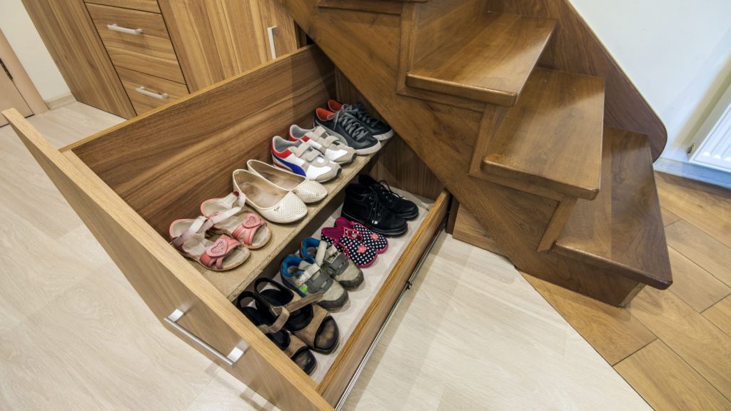 wooden stairs with custom built pullout cabinets on glides