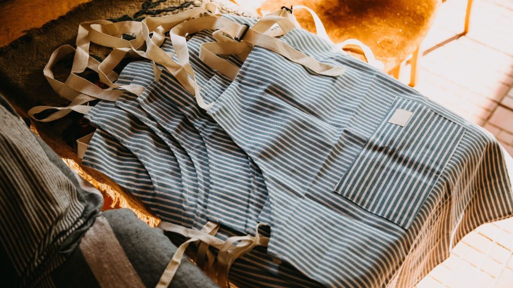 Cotton striped aprons lying on a table
