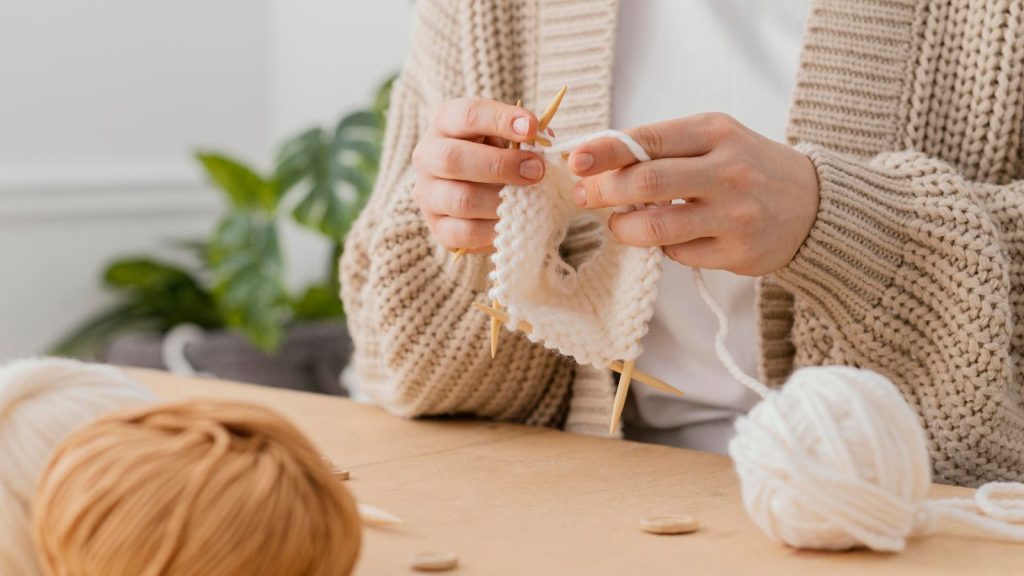 close-up photo of woman knitting