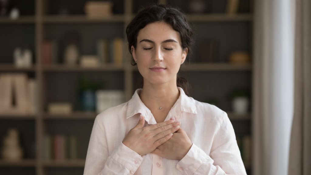 a woman practice mindful breathing