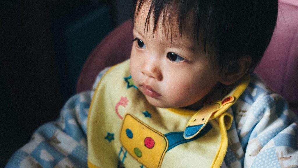 Baby wearing a yellow bib