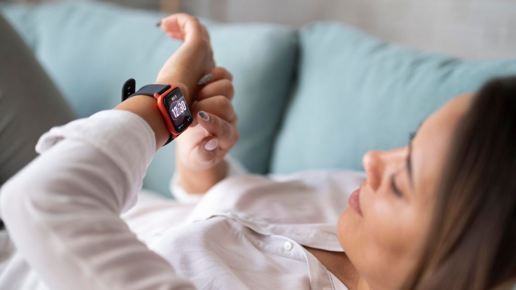 woman lying with smartwatch