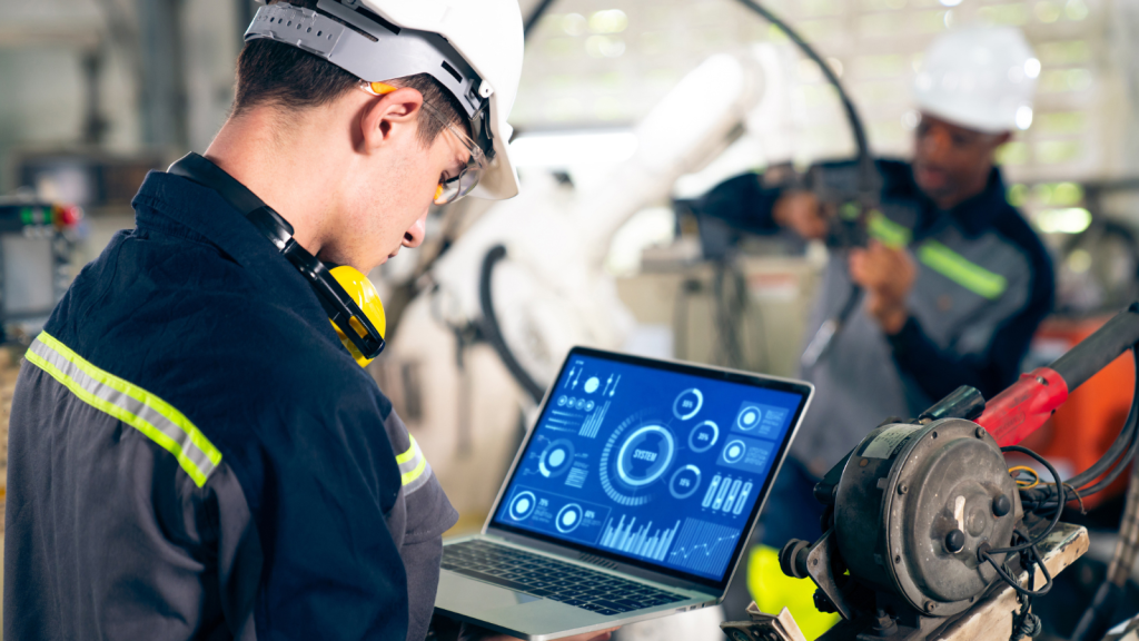 Young factory worker working with adept robotic arm