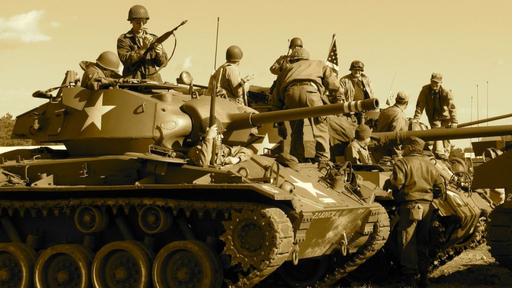 a group of soldiers riding a war tank