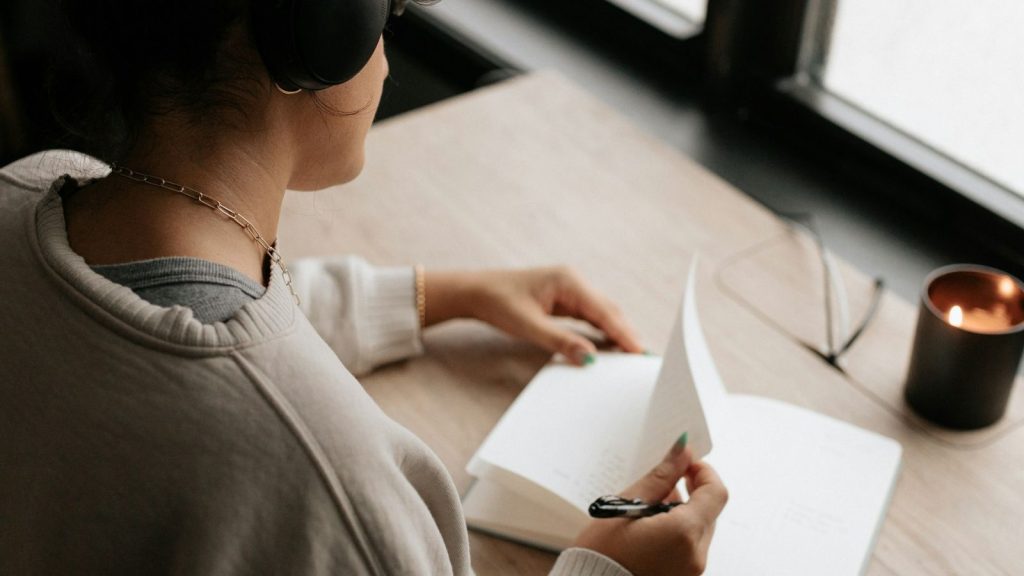 a woman is about to write in her journal