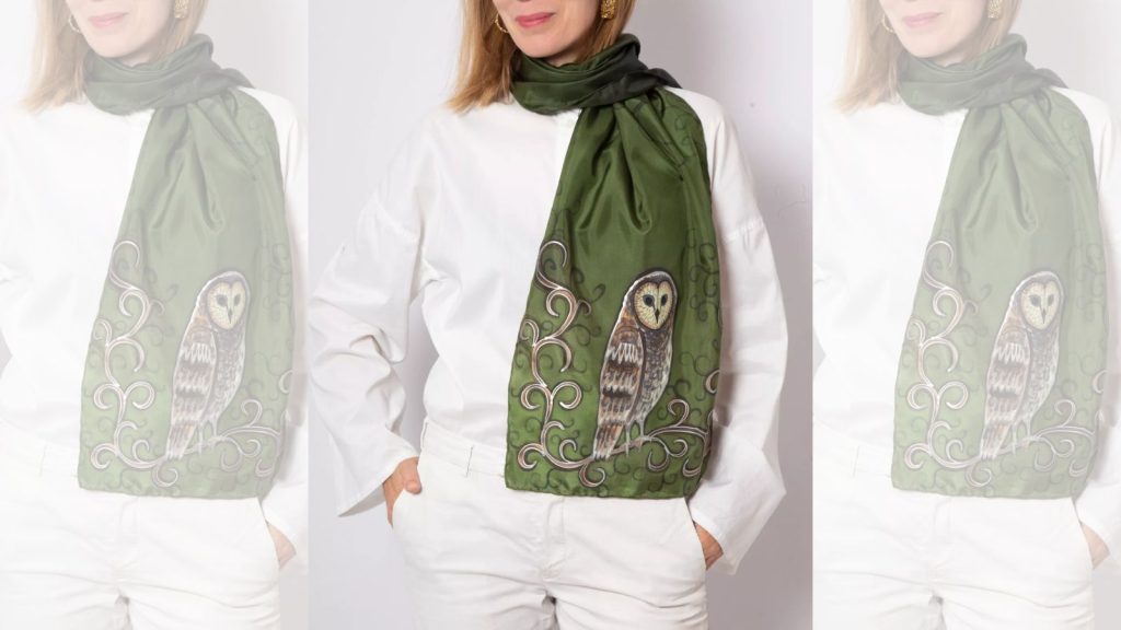 Woman wearing owl hand painted pure silk green scarf.