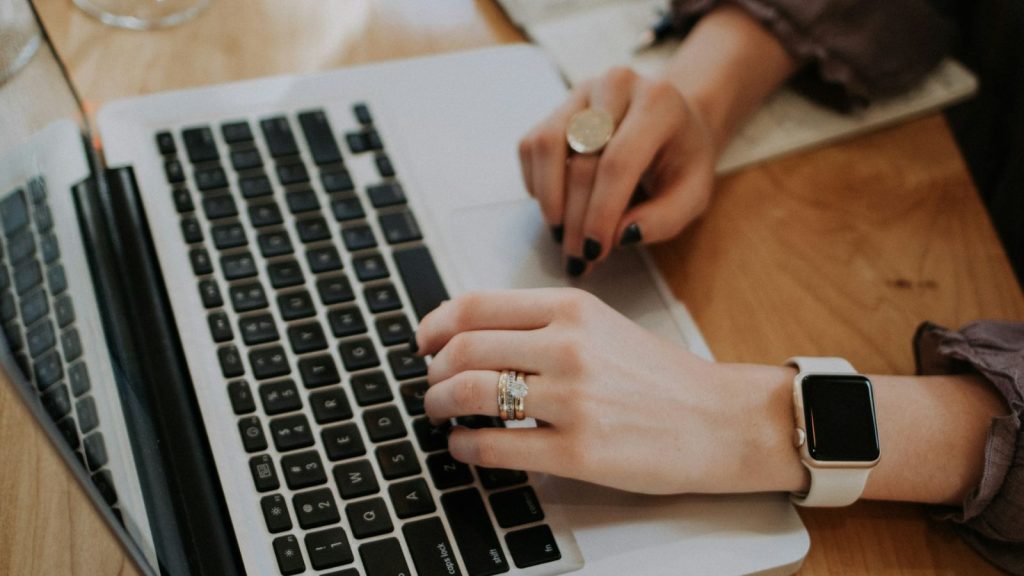 woman typing on a laptop