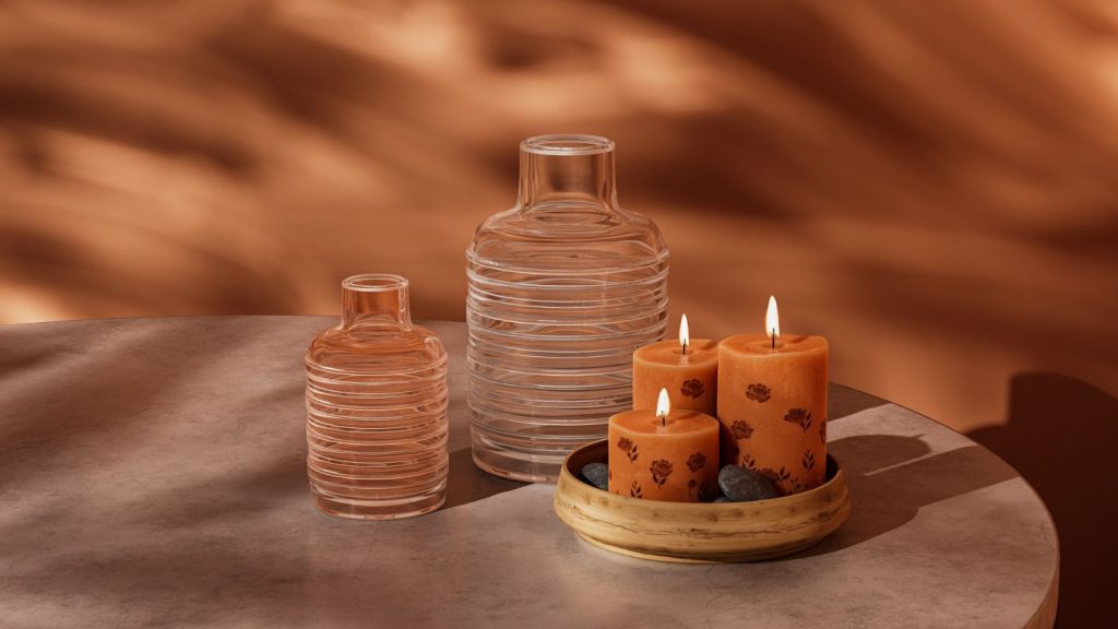 three lit candles on a circular tray 