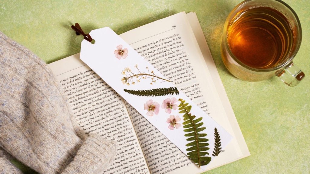 Open book with pressed flowers bookmark.